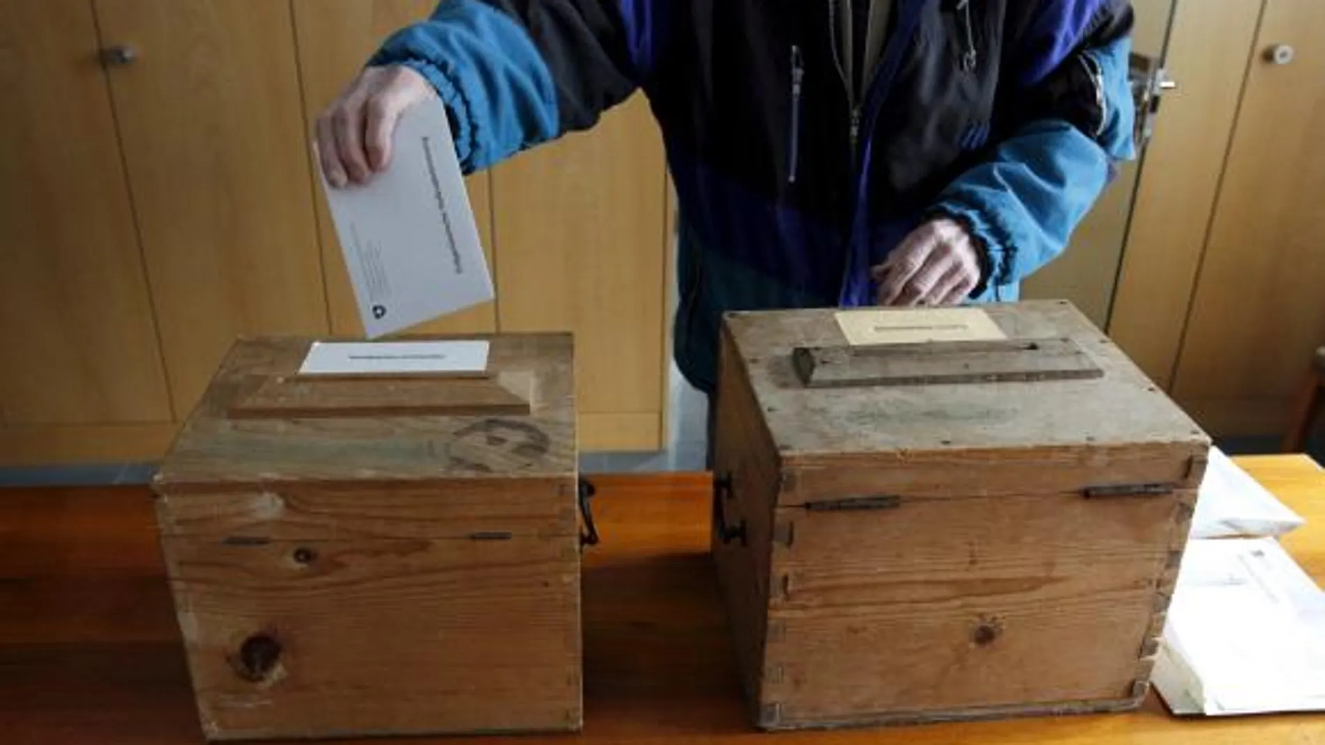 Un hombre suizo vota en un referéndum sobre una iniciativa que pretende establecer la expulsión automática de los extranjeros que hayan cometido delitos graves en Bauen, Suiza, hoy domingo 28 de noviembre de 2010