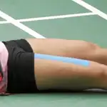Carolina Marín, tumbada en el suelo con las manos en la cara tras ganar el último punto de la final