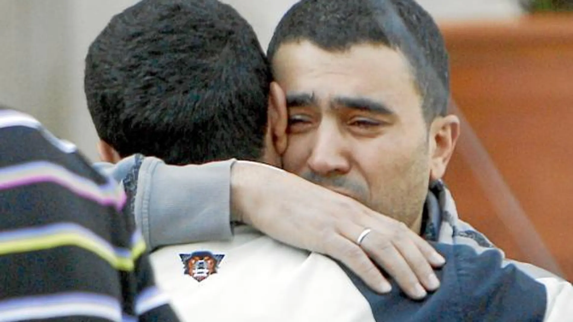 Rachid se abraza a un familiar en el funeral por su mujer que se celebró ayer en la Mezquita de la M-30