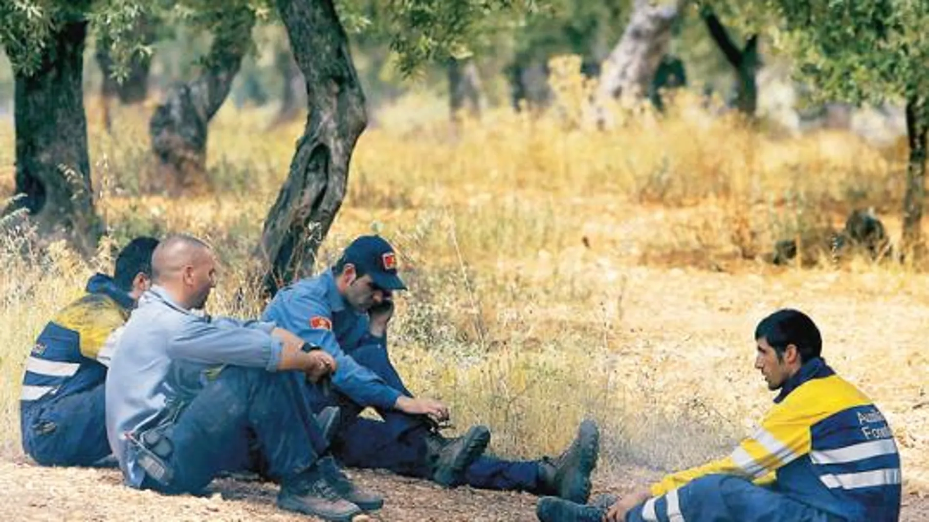 Compañeros de las víctimas del incendio de Tarragona hacen un descanso en las tareas de extinción