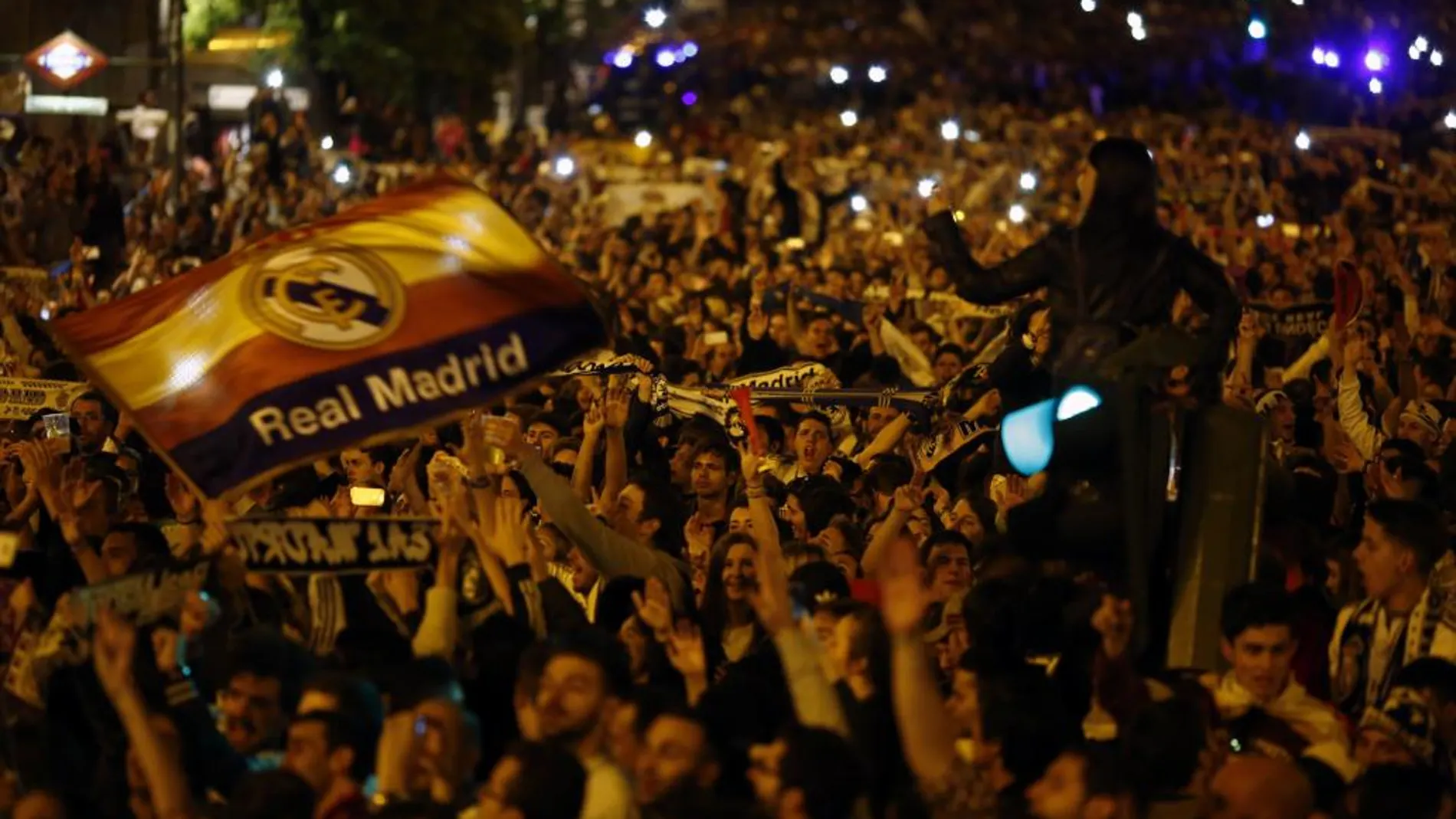 Aficionados del Real Madrid celebran la consecución de la Liga de Campeones en la madrileña plaza de Cibeles,