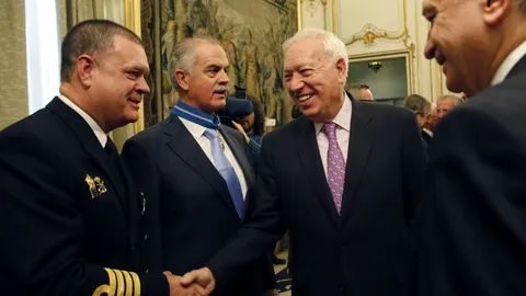 El ministro de Exteriores, José Manuel García-Margallo (2d), y el titular del Interior, Jorge Fernández Díaz (d), saludan a Pedro Díez (i), capitán de navío, y Julio Berzosa, capitán marítimo, durante el acto de imposición de condecoraciones