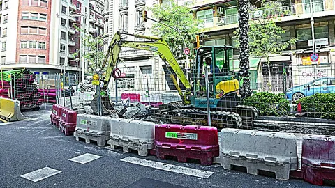 A la izquierda, los operarios trabajan en la última etapa de la ronda del general Mitre, mientras en Lesseps los vecinos esperan a que tapen el pozo de obra de la L9.
