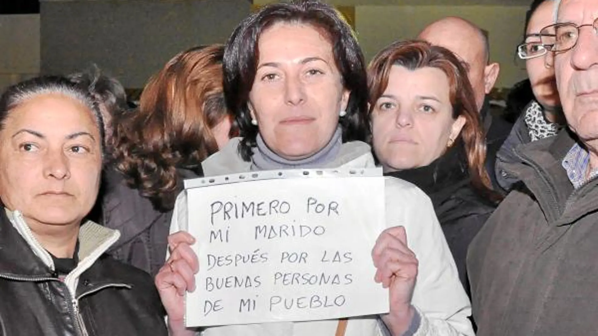 La mujer del agente de la Policía Local que liberó Helena, de 14 años, muestra un cartel contra la «injusta» detención de su marido