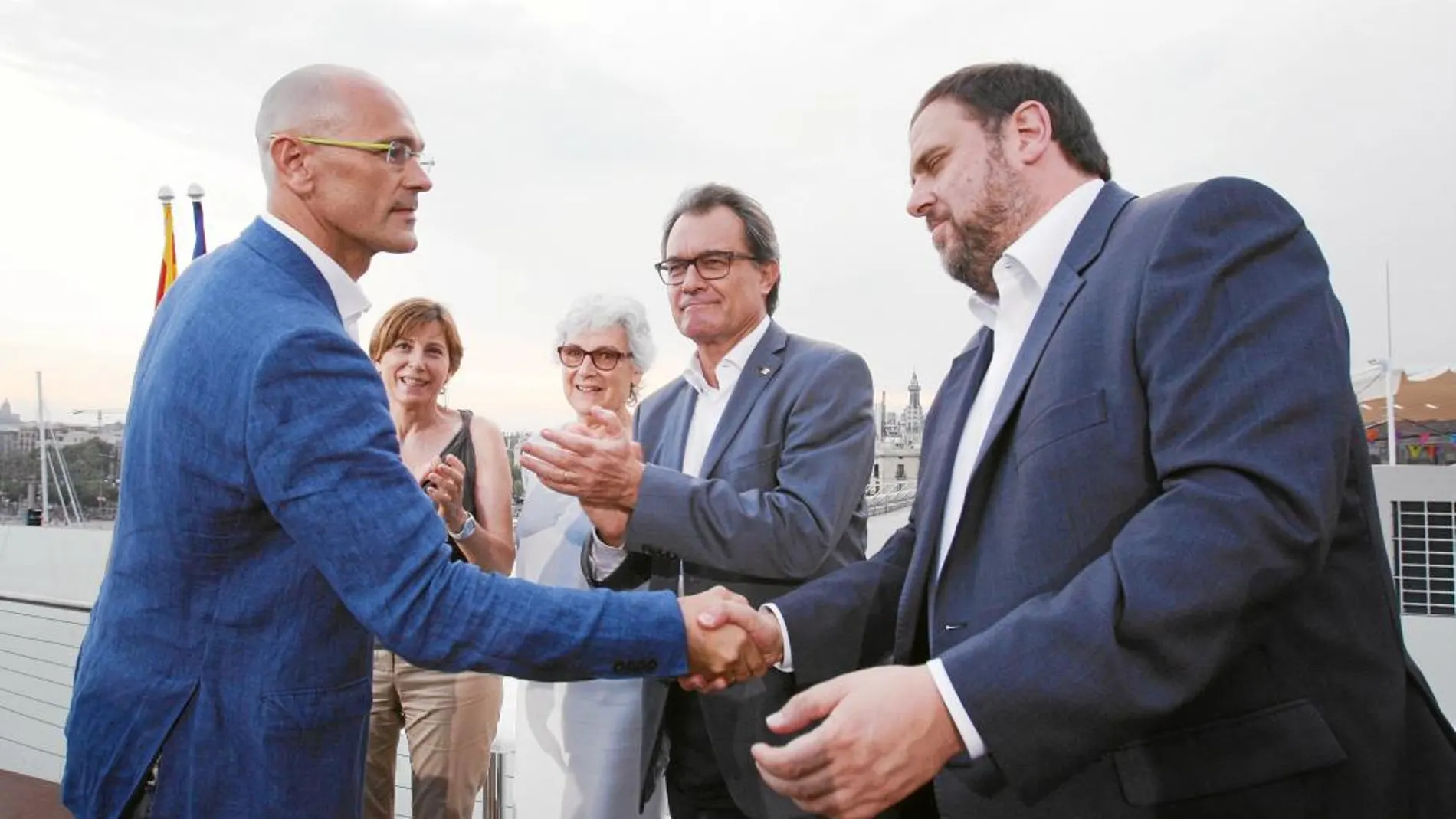 Raúl Romeva saluda a Oriol Junqueras en presencia de Mas y Murial Casals, el pasado 27 de julio