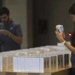 Una vendedora escanea uno de los modelos de Iphone 6s