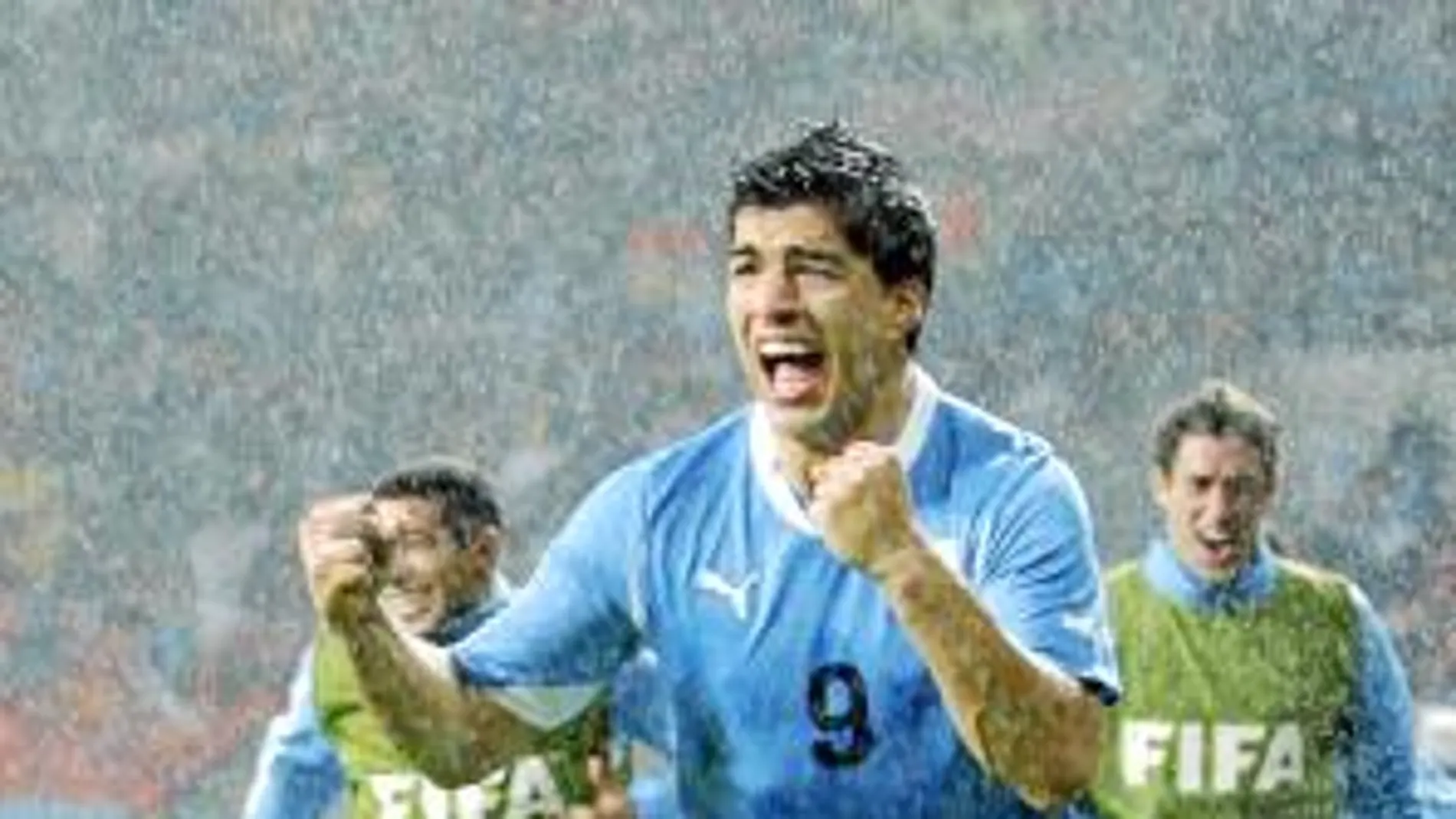 Luis Suárez, bajo la intensa lluvia, celebra eufórico el segundo gol a Corea del Sur, que permitió la clasificación de Uruguay