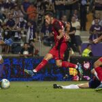 Pablo Sarabia (c) del Sevilla FC marca un gol ante el guardameta Filip Pajovic (i) del Újpest FC / Efe