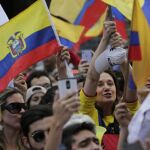 Supporters cheer on CREO's presidential candidate Guillermo Lasso outside the Electoral National Council, in Quito, Ecuador, Tuesday, Feb. 21, 2017. The Andean country is headed to a presidential runoff as ruling party candidate Lenin Moreno faces off against Lasso, a conservative former banker. (AP Photo/Dolores Ochoa)