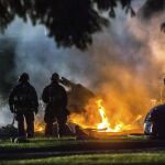 Dos bomberos trabajan para extinguir las llamas