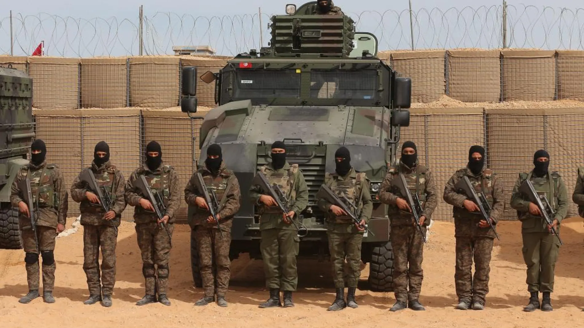 Soldados tunecinos posan junto al muro cerca de Ben Guerdane, al este de Siria, cerca de la frontera con Libia.