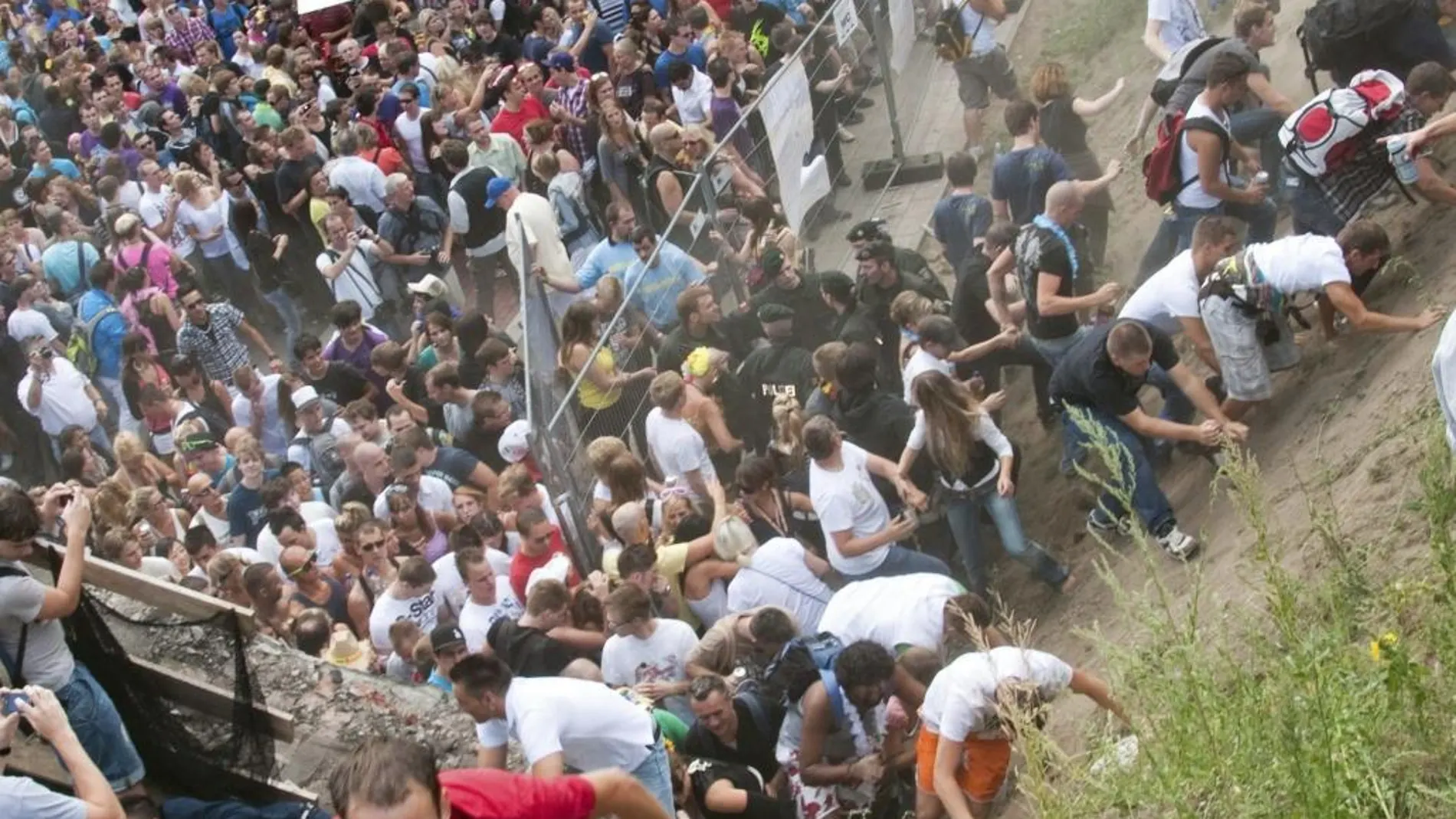 Fotografía de archivo fechada el 24 de julio de 2010 que muestra a varias personas mientras intentan abandonar un túnel durante una estampida en la tragedia de la Loveparade de 2010, en Duisburgo