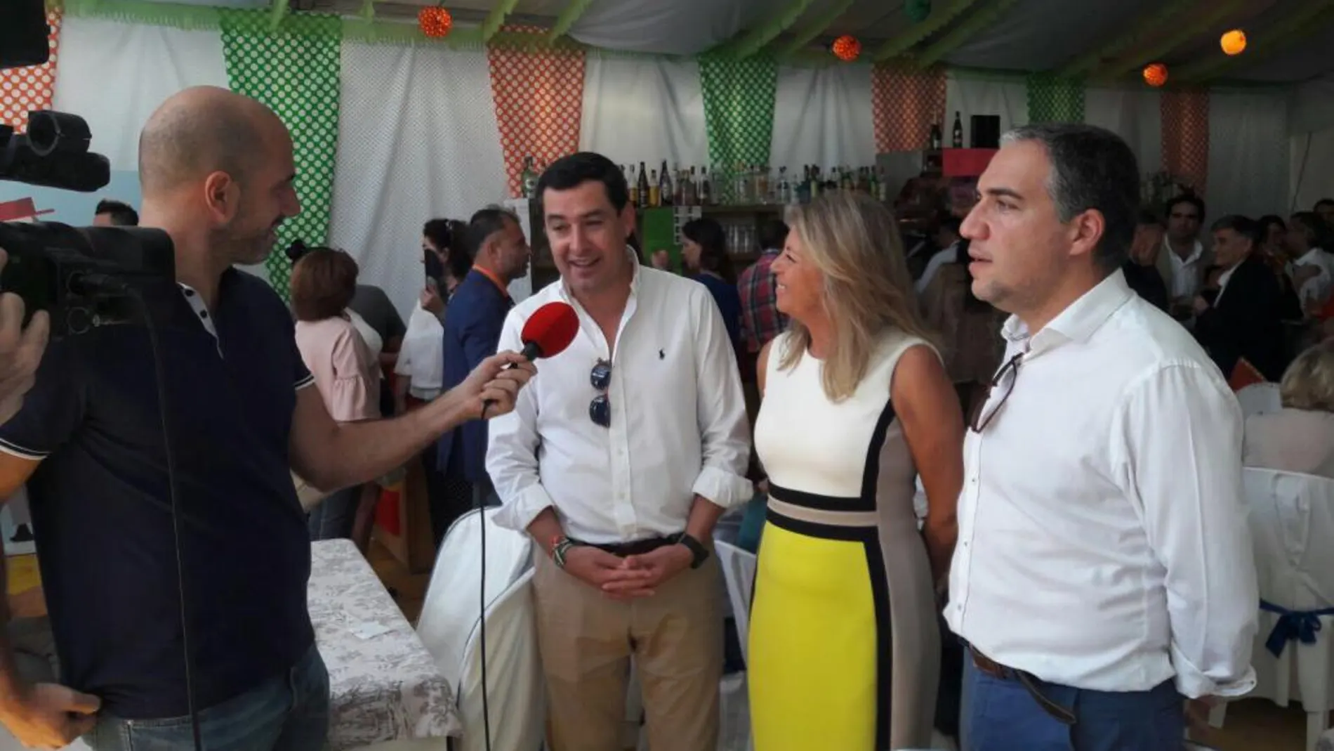 Juanma Moreno, en las fiestas de San Pedro de Alcántara, atiende a los medios junto a Ángeles Muñoz y Elías Bendodo