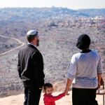 Una familia israelí observa un asentamiento judío desde una colina