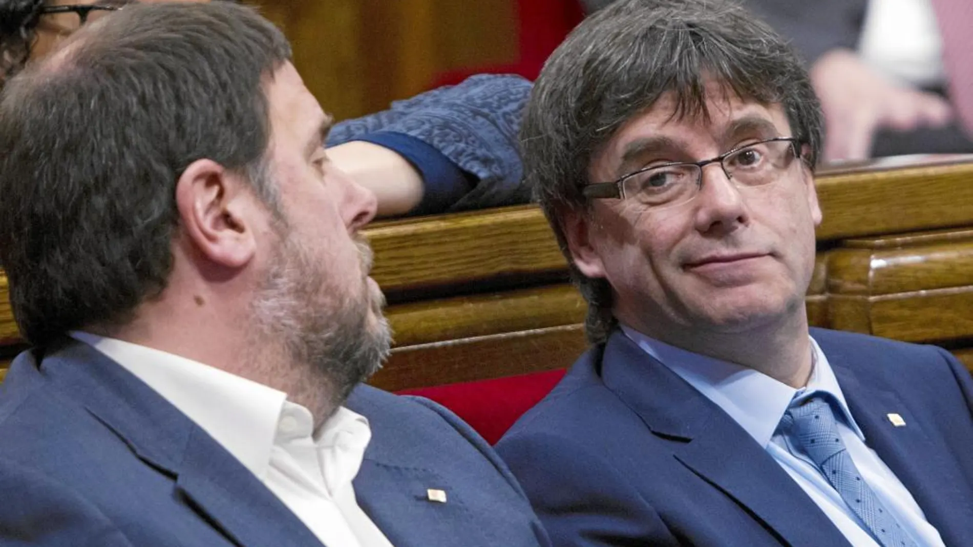 Carles Puigdemont y Oriol Junqueras intercambian pareceres en un momento del pleno