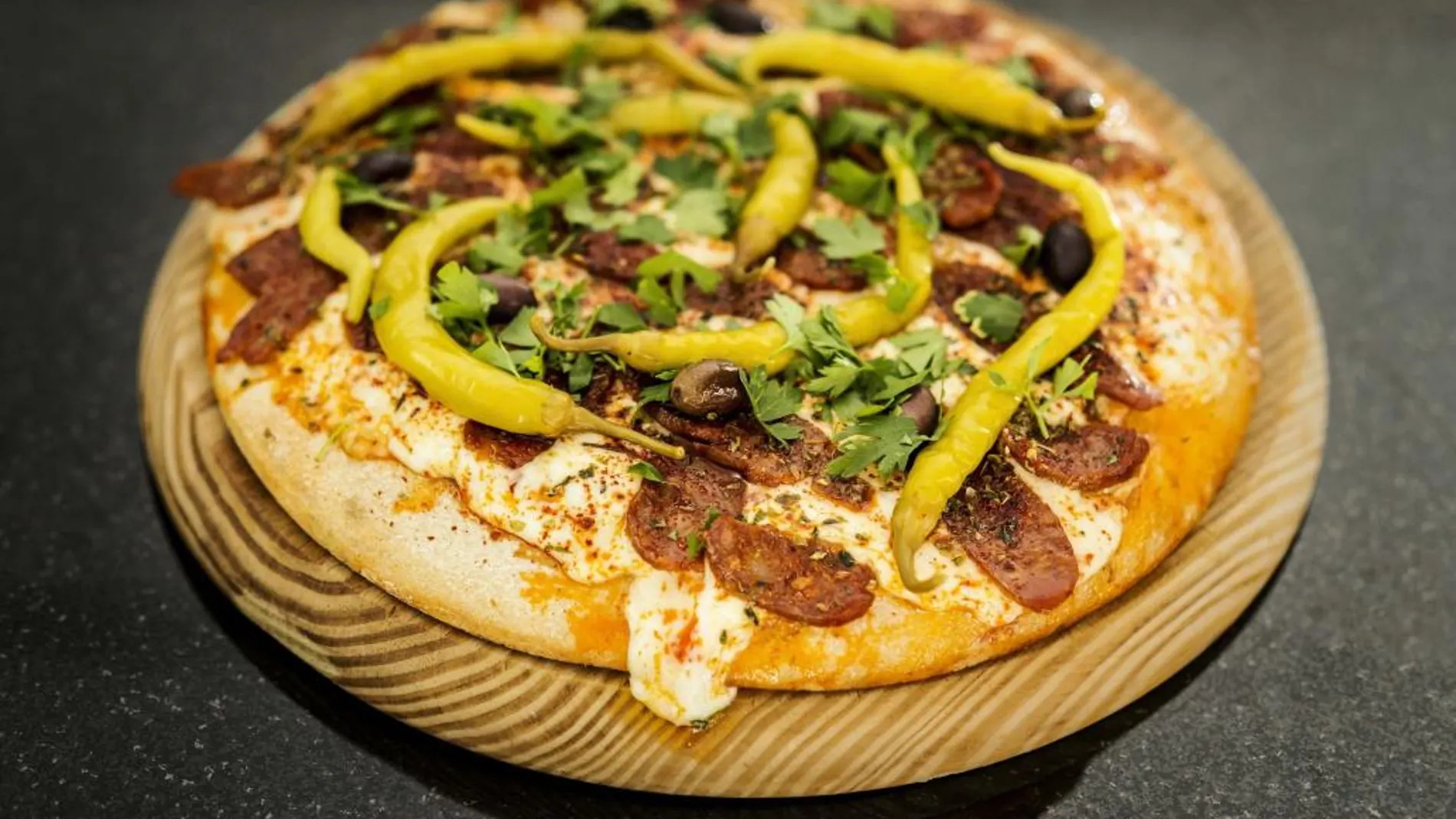 La pizza calabresa, con chorizo picante, queso Picsa, piparras en vinagre y aceituna negra, es una de las más originales