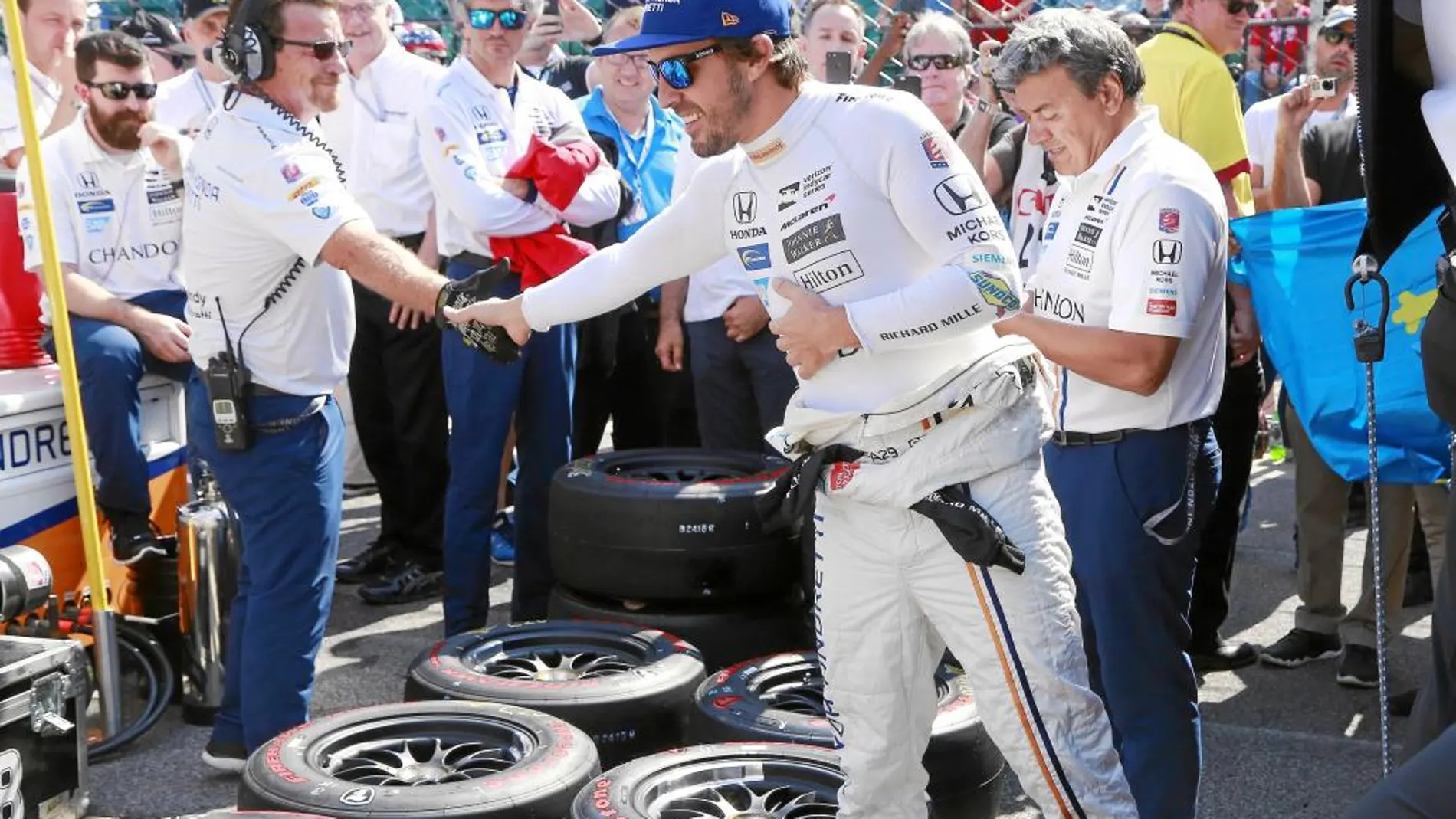 Fernando Alonso da la mano a un miembro de su equipo durante la sesión de entrenamiento de ayer