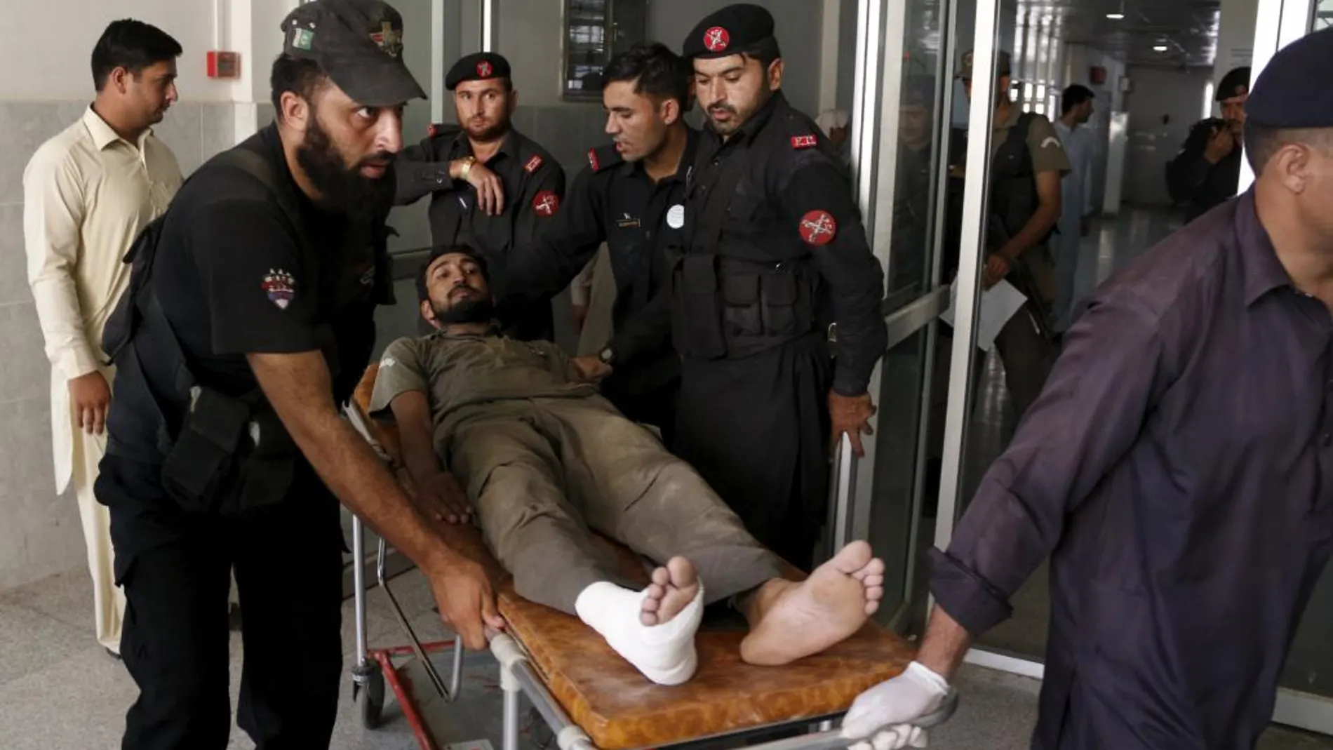 Los servicios de emergencia trasladan a un heridos tras el ataque a una base militar en Peshawar.