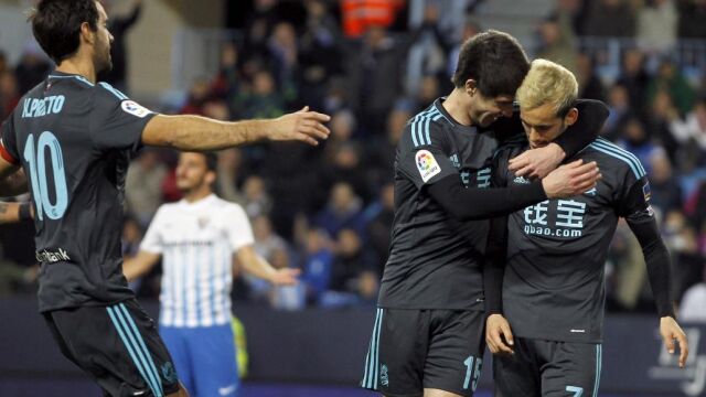 El delantero de la Real Sociedad Juanmi Jiménez (d) celebra su gol, segundo del equipo ante el Málaga CF, con su compañero Aritz Elustondo
