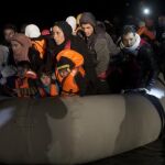 Los equipos de rescate ayudan a un grupo de refugiados llegados de madrugada a las costas griegas.