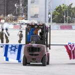 Un operario coloca banderas en el aeropuerto Ben Gurion de Tel Aviv