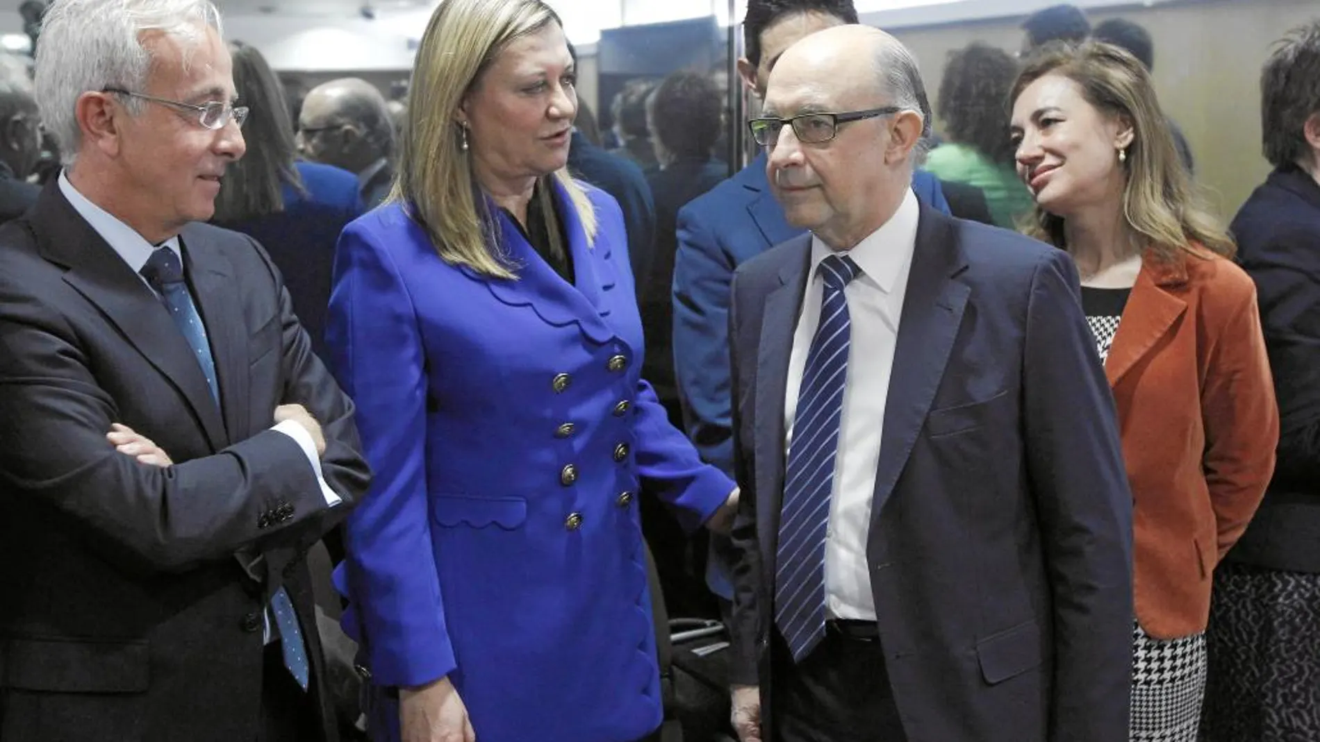 Pilar del Olmo y Javier de Andrés Guijarro saludan a Cristóbal Montoro, en el encuentro de ayer en Madrid