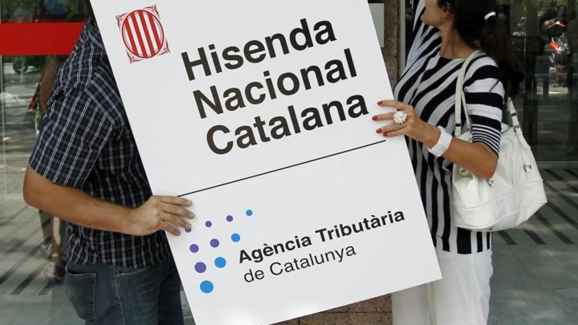 Imagen de archivo de dos miembros de ERC colocando un cartel de la hacienda nacional catalana