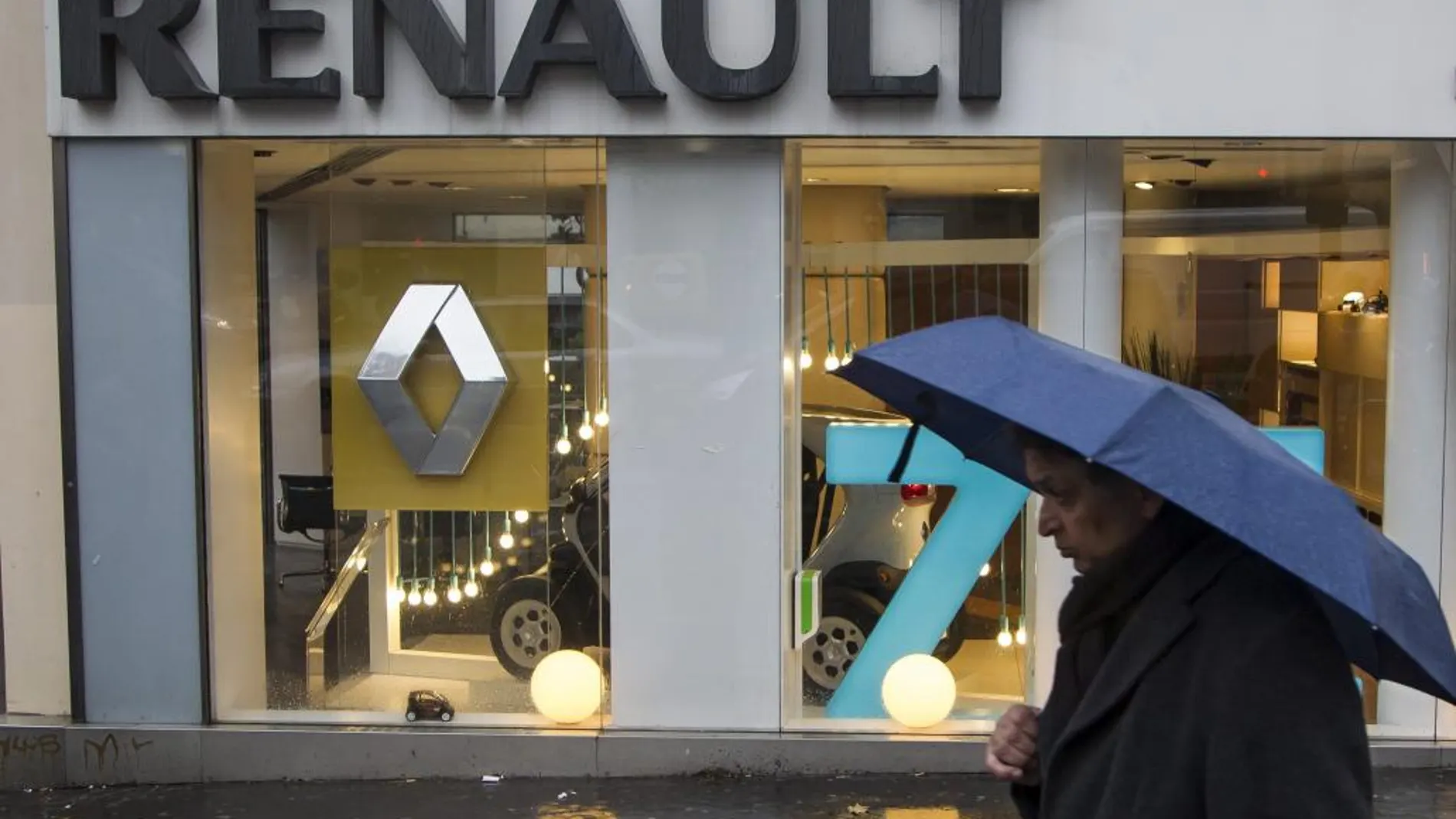 Un hombre camina junto a un concesionario de Renault en París, Francia