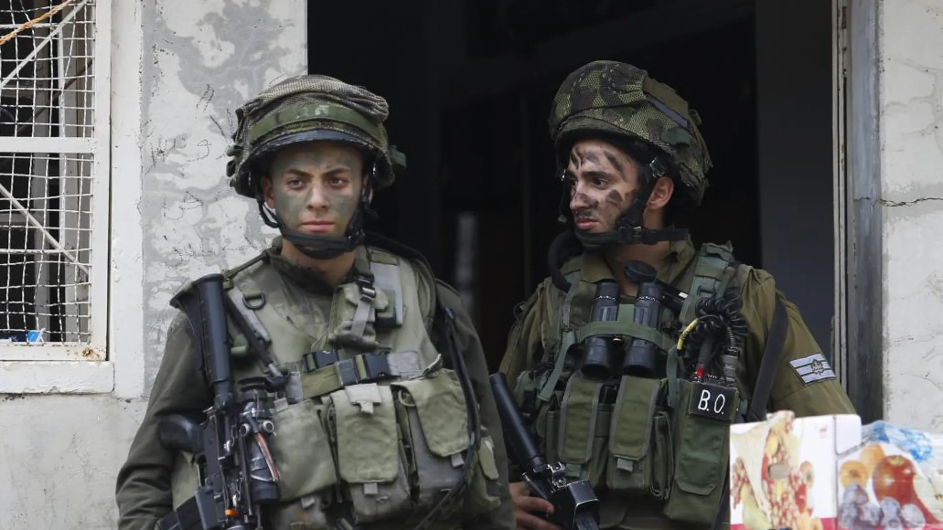 Soldados israelíes en la puerta de una casa palestina en la ciudad cisjordana de Hebrón