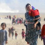 Una familia que pertenece a la minoría yazidí huye de Estado Islámico, que ha tomado el control de la ciudad de Sinjar