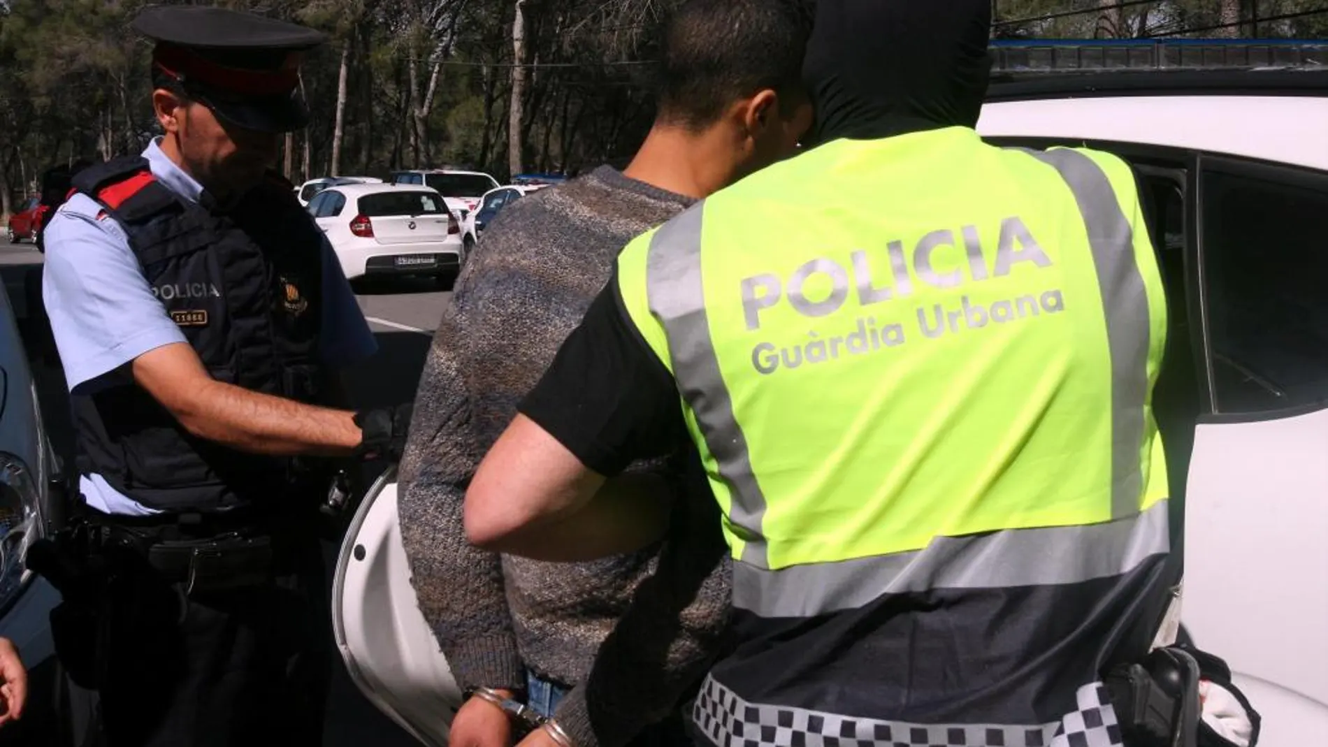 Agentes de la Guardia Urbana de Tarragona y los Mossos d'Esquadra trasladan a uno de los detenidos en la operación que están desarrollando en el barrio de Sant Salvador de Tarragona contra el tráfico de cocaína
