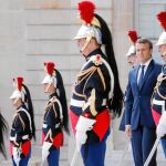 El presidente de la República francesa, Emmanuel Macron, rodeado de la guardia presidencial, ayer, en los jardines del Palacio del Elíseo