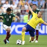 El mexicano Carlos Vela lucha por un balón en presencia del sueco Viktor Claesson / Ap