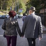Una pareja de ancianos pasea por Madrid
