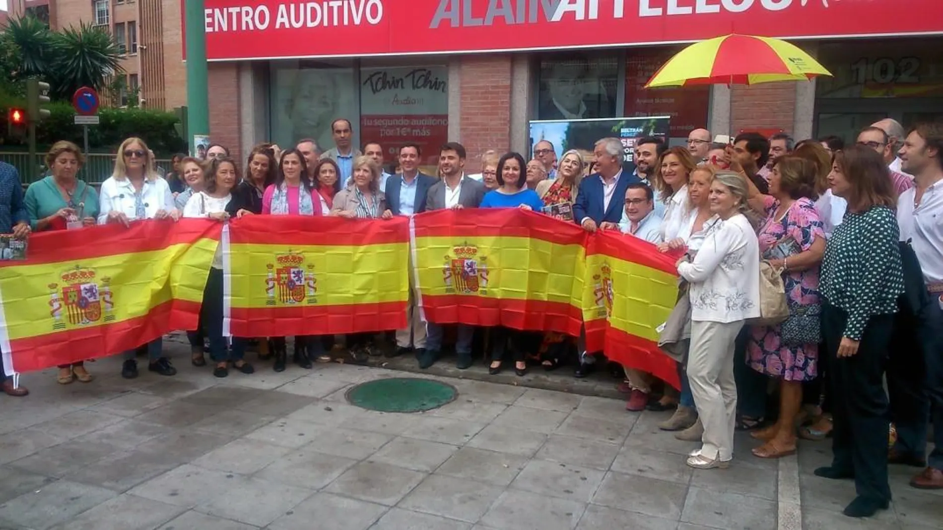 El PP reparte banderas de España y cubre su sede con ella para animar a enarbolarla «sin complejos»