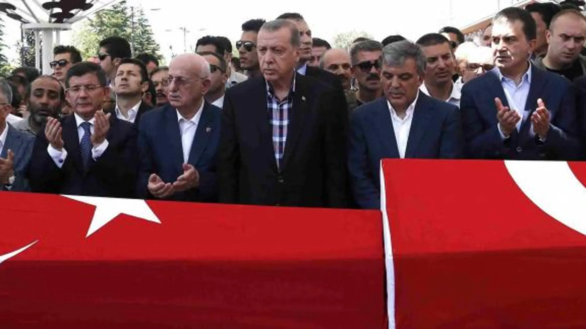 Erdogan, en el centro, reza ante los ataudes de dos de las víctimas asesinadas durante el golpe fallido del pasado viernes.