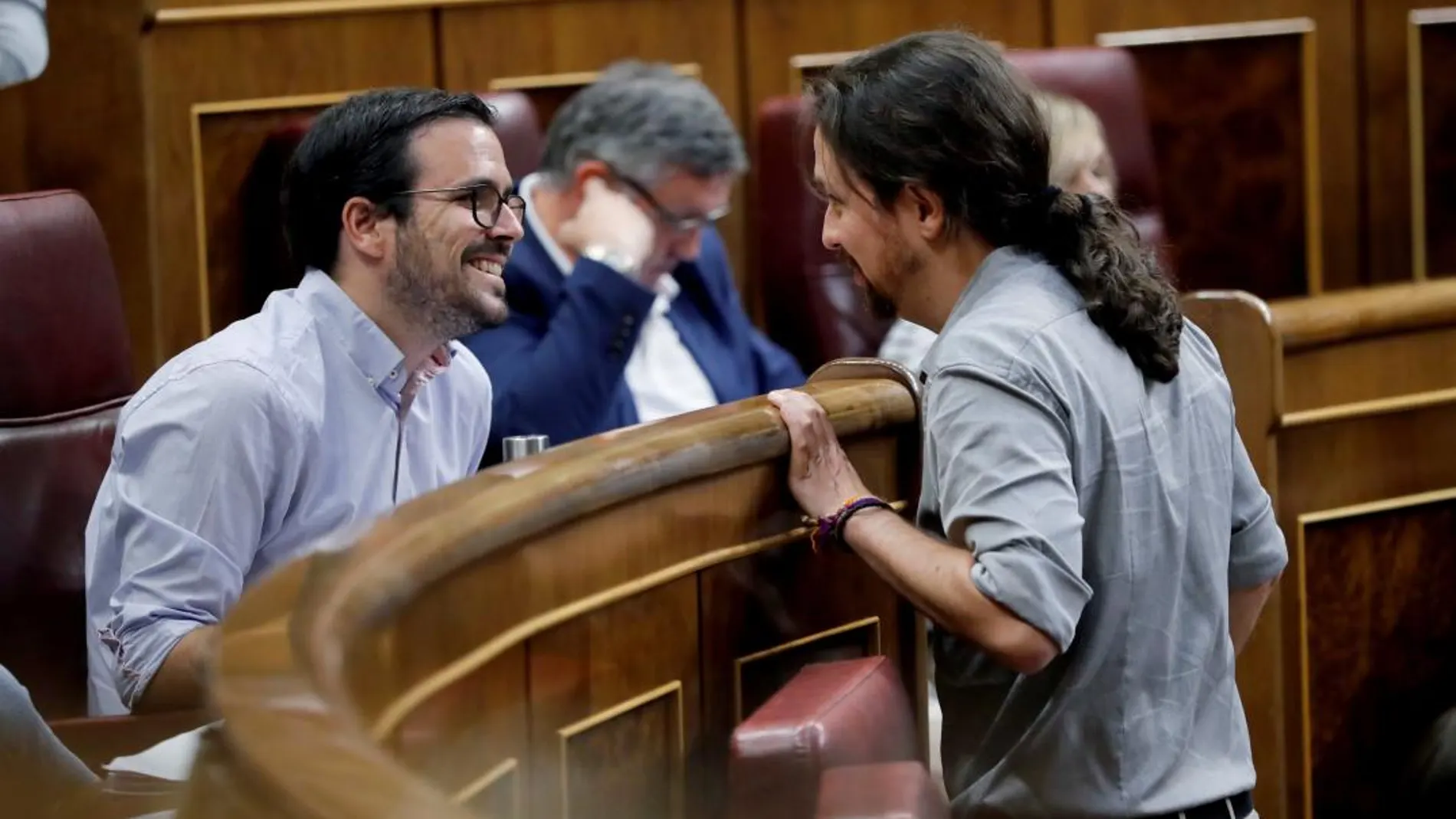 El coordinador federal de IU Alberto Garzón (i) y el líder de Podemos, Pablo Iglesias, durante el pleno del Congreso de los Diputados. EFE/Juan Carlos Hidalgo
