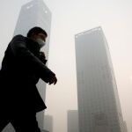 Un peatón se protege con una máscara de la contaminación en Pekín / Reuters
