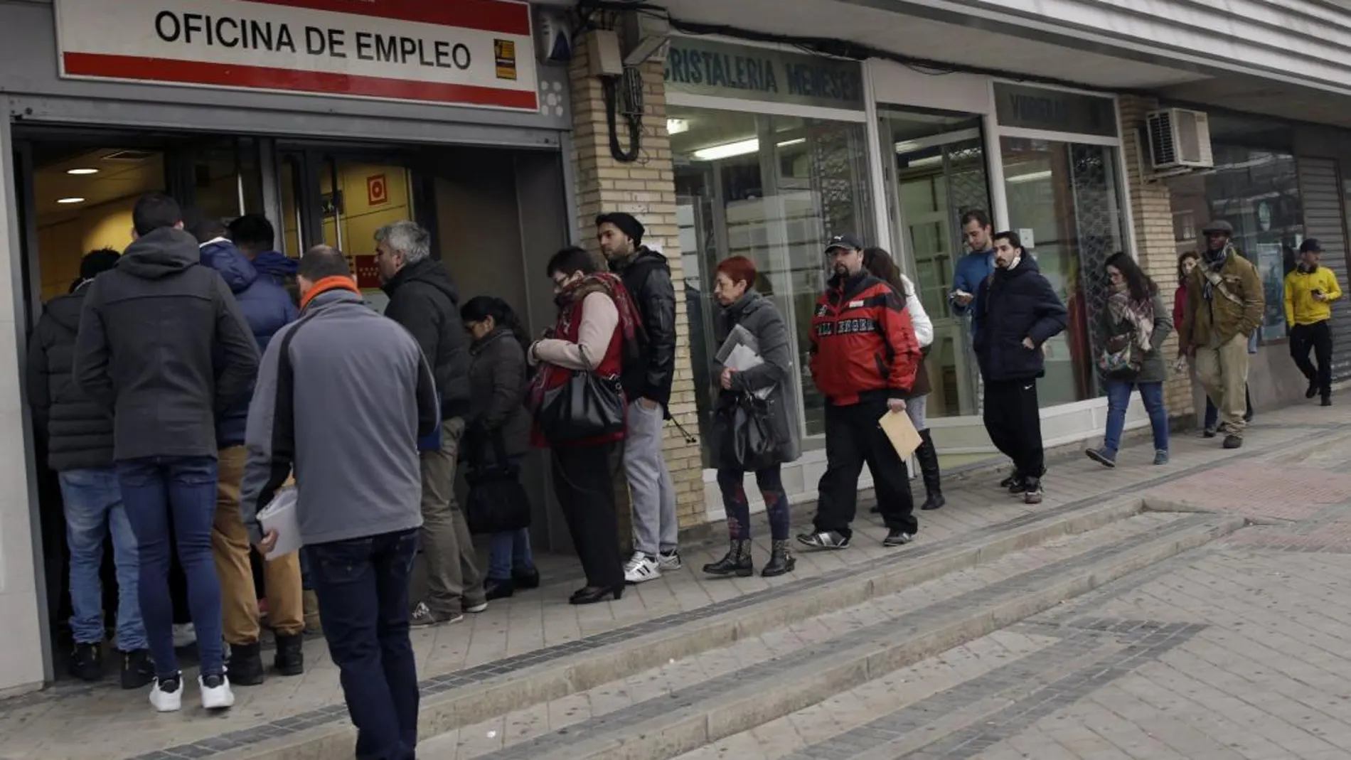 Parados hacen cola ante una oficina de empleo en Madrid