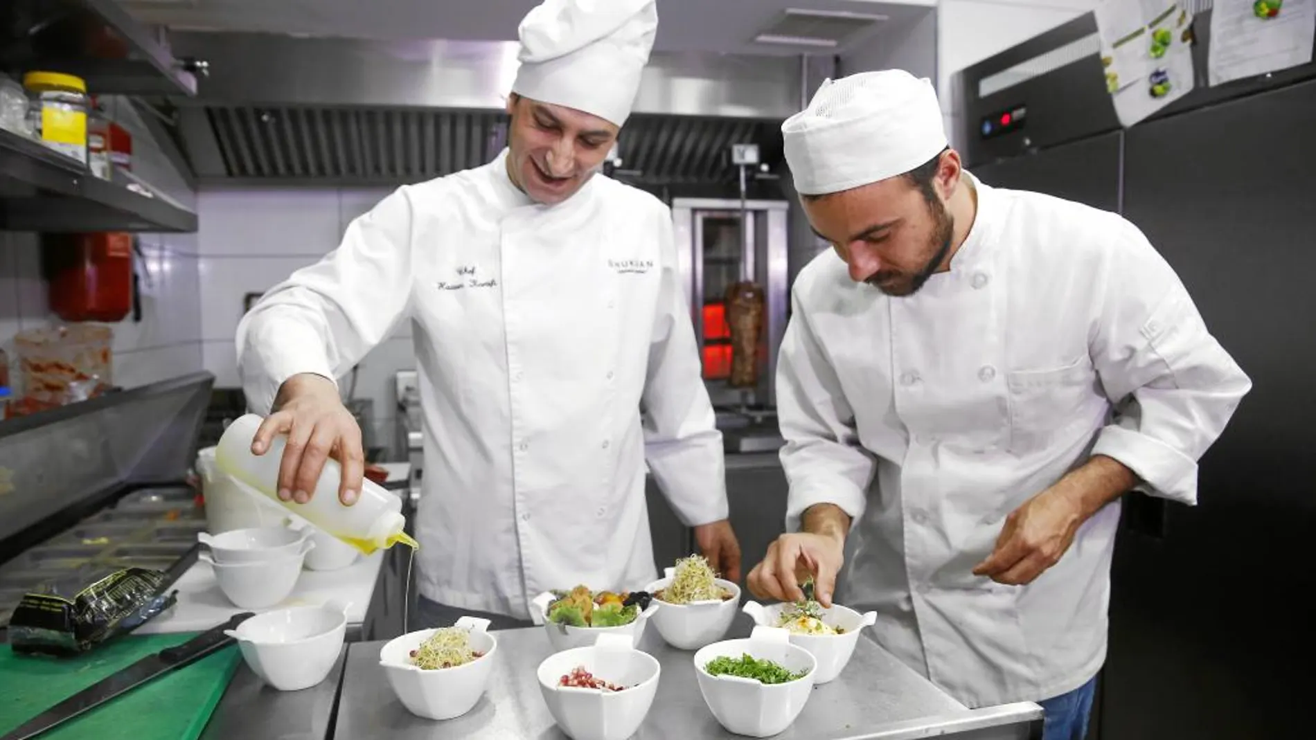 Hassan Karsifi (a la izda.) y Marcos Carvajal le dan el último toque a los platos a punto de salir a la mesa