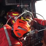 Una mujer y su hijo en un helicóptero de la Guardia Costera italiana tras ser rescatados en el Mar Mediterráneo