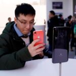 Un visitante toma fotos del nuevo Xiaomi Mi 9, durante su presentación este miércoles en Pekín (China) / Efe