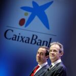 El presidente de CaixaBank, Jordi Gual (dcha), y el consejero delegado, Gonzalo Gortázar, al comienzo de la junta general de accionistas,