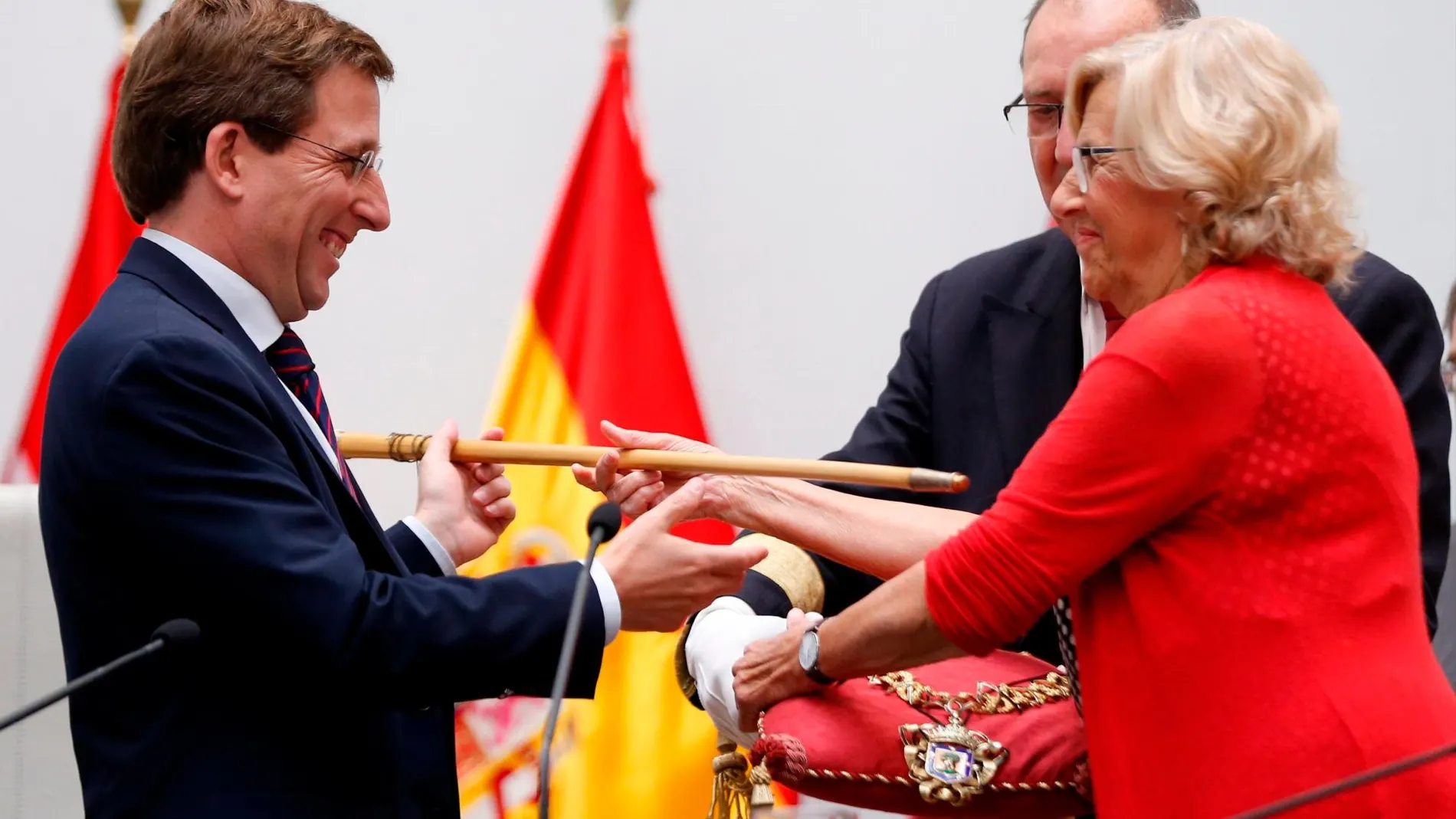 Manuela Carmena entrega el bastón de mando al cabeza de lista del PP al Ayuntamiento de la capital de España, José Luis Martínez Almeida