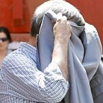 El que fue asesor del exalcalde socialista de Sevilla Alfredo Sánchez Monteseirín, Domingo Enrique Castaño (tapado la cabeza con chaqueta), tras ser detenido