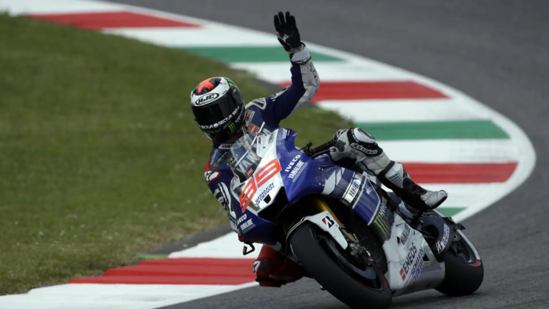Spain's Jorge Lorenzo waves to fans at the end of the official practice for Sunday's Italian Moto GP, at the Mugello race circuit, in Scarperia, Italy, Saturday, June 1, 2013. (AP Photo/Gregorio Borgia)