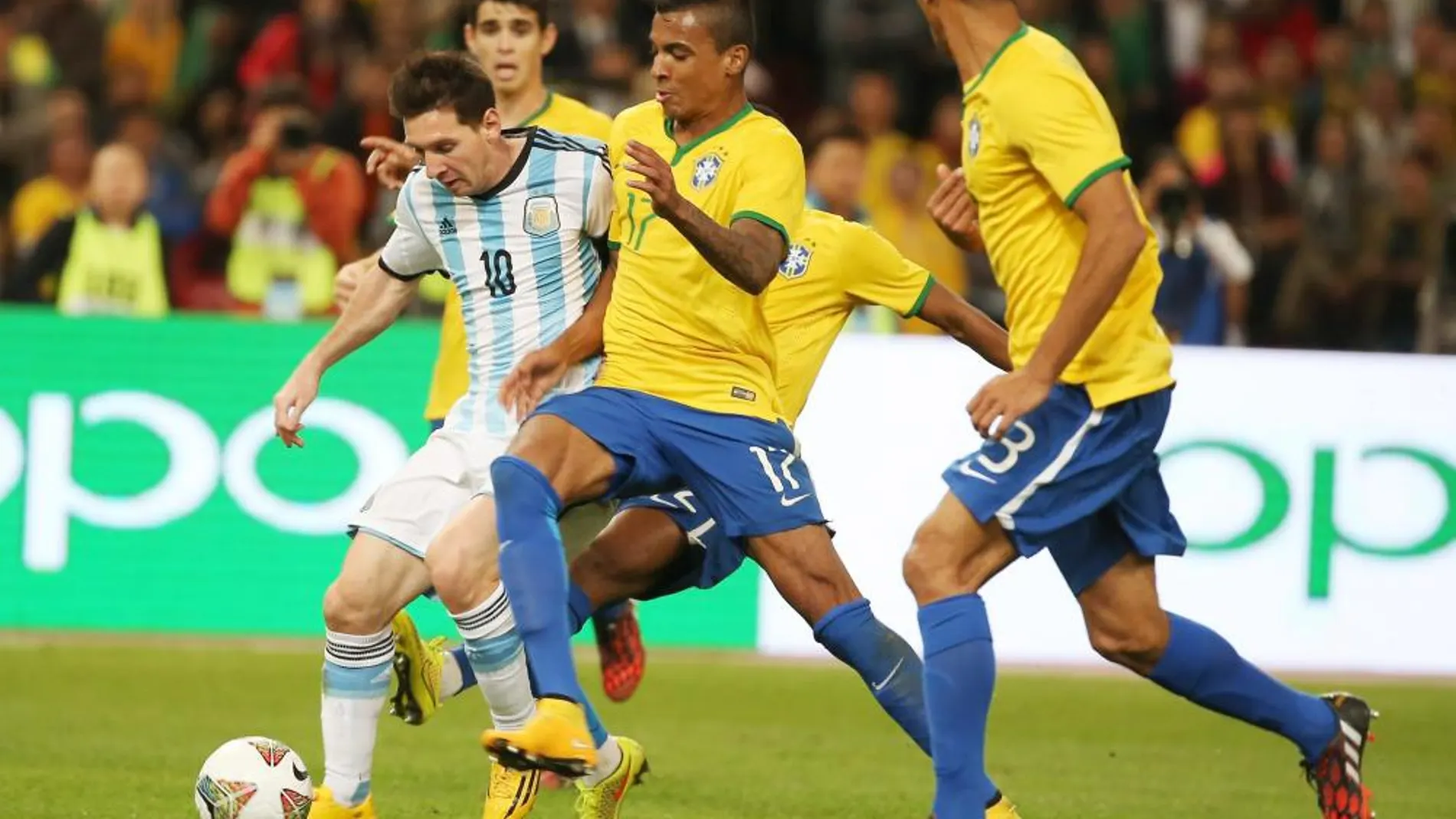 Lionel Messi trata de llevarse el balón ante el asedio de los brasileños en el Superclásico de las Américas