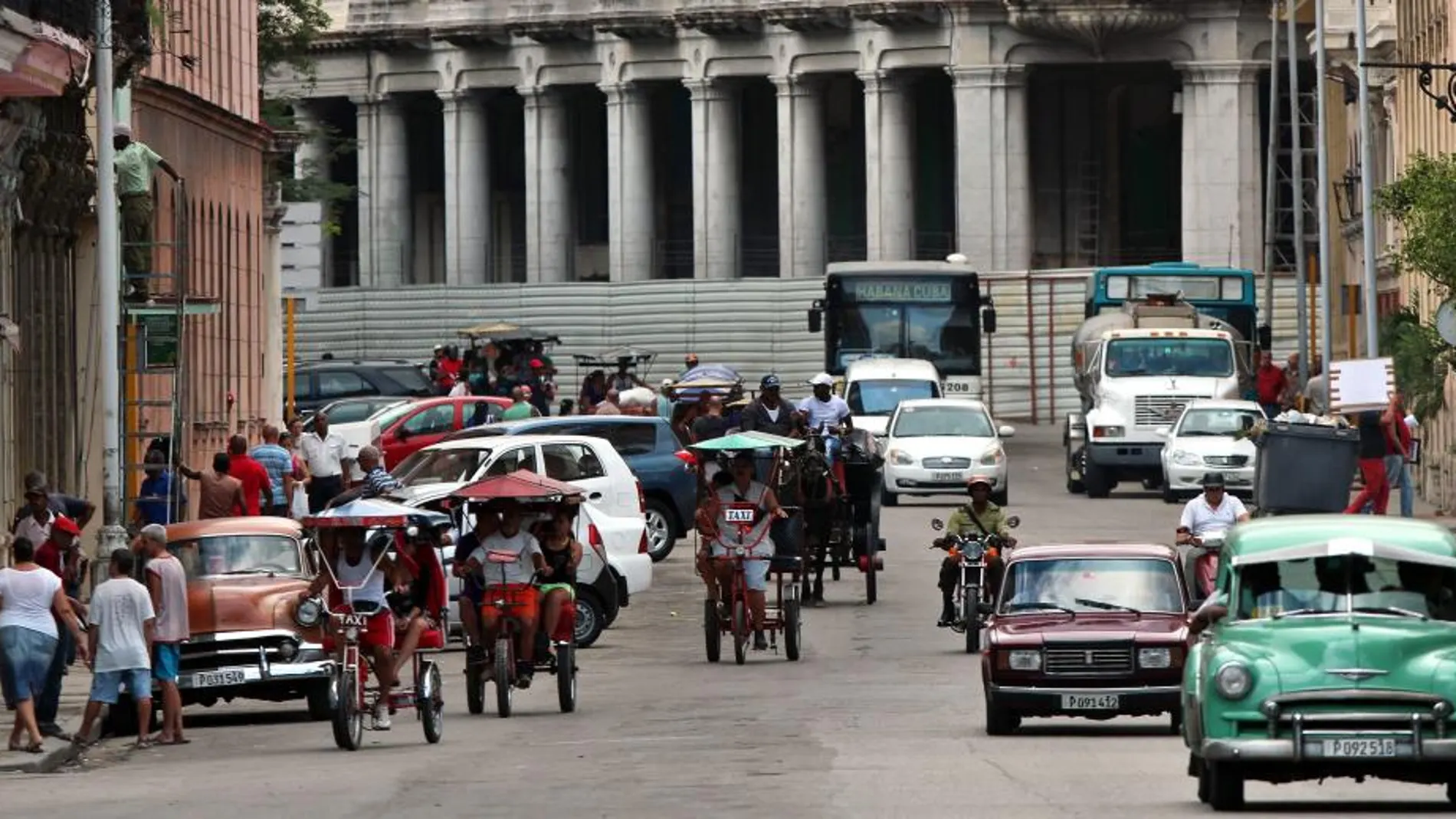 Varios bicitaxis circulan por una calle de La Habana (Cuba)