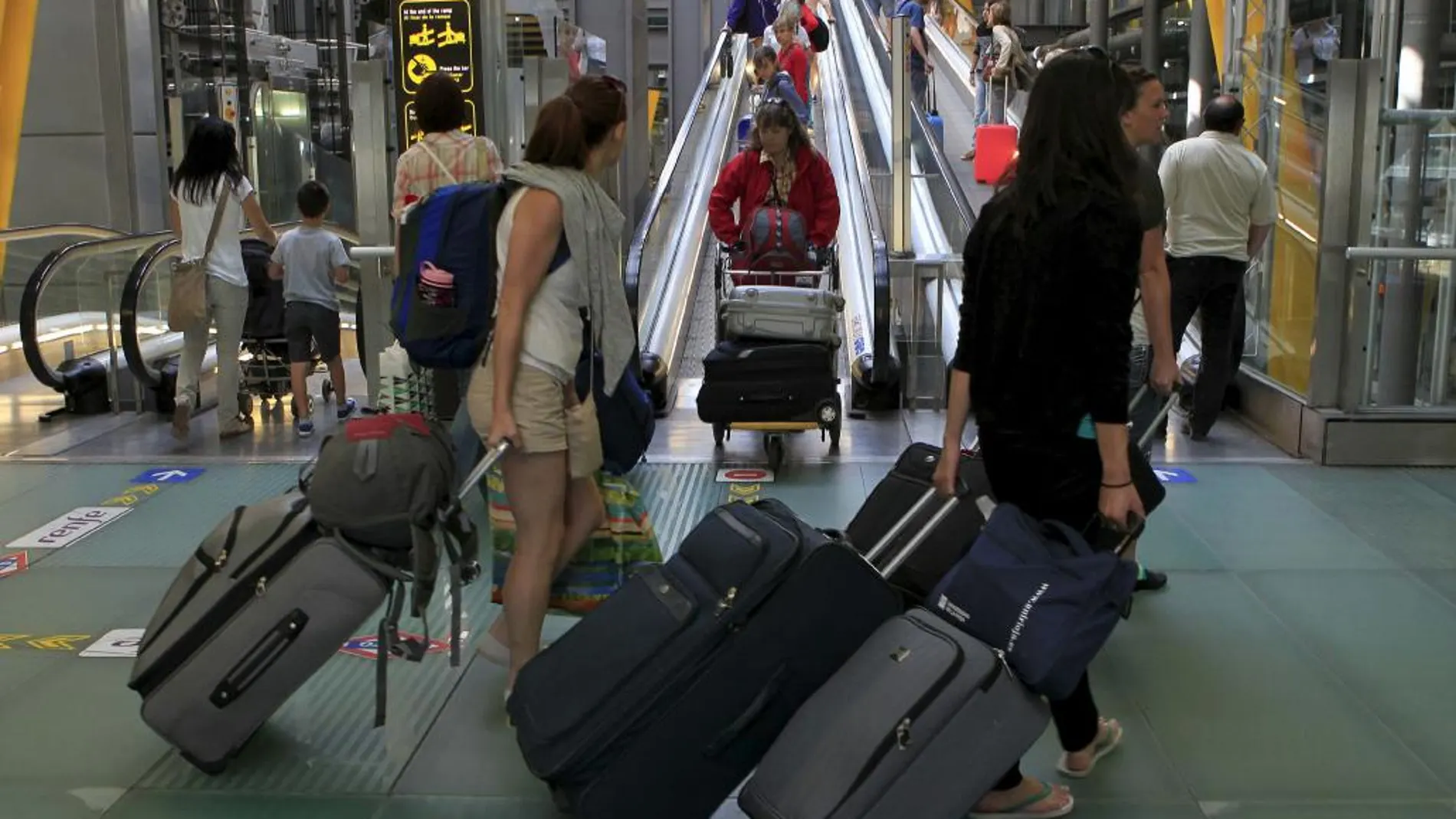 Varias personas, antes de facturar sus equipajes en la T4 de Madrid-Barajas