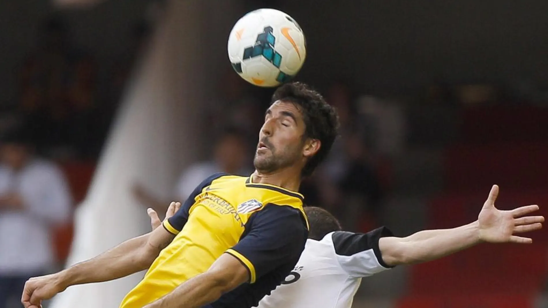 El defensa del Valencia José Luis Gayá (d), pelea un balón con el centrocampista del Atlético de Madrid Raúl García